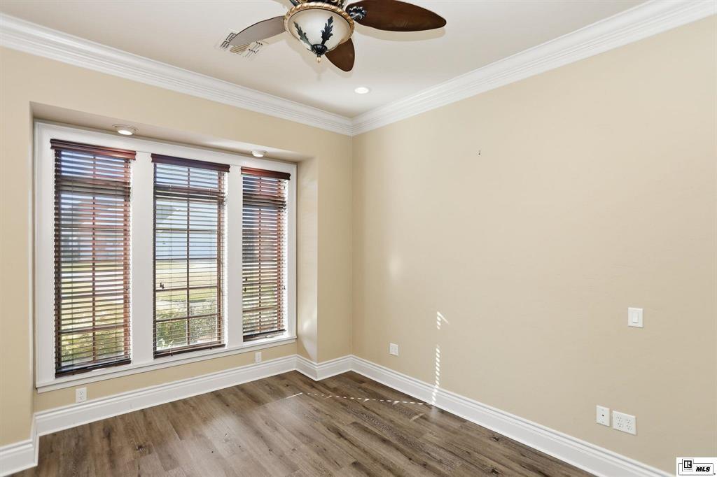 114 Apache Trail Delhi, LA 71232 - Photo 30 of 38 a view of an empty room with a window and wooden floor
