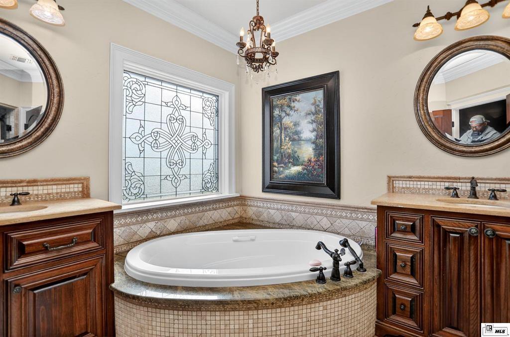 114 Apache Trail Delhi, LA 71232 - Photo 33 of 38 a bath tub sitting next to a bathroom sink and a mirror