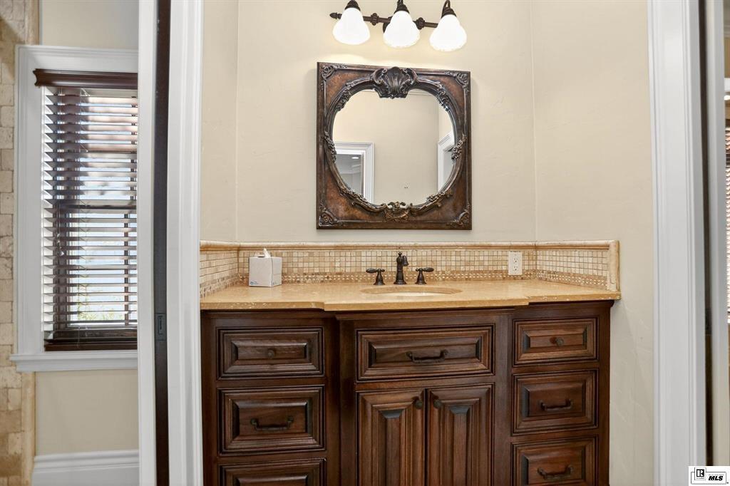114 Apache Trail Delhi, LA 71232 - Photo 36 of 38 a bathroom with a sink and a mirror
