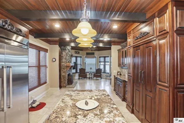 a view of a hallway with dining table and chairs