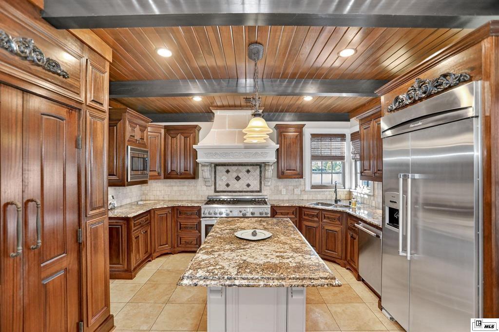 114 Apache Trail Delhi, LA 71232 - Photo 10 of 38 a kitchen with stainless steel appliances granite countertop a sink window and refrigerator