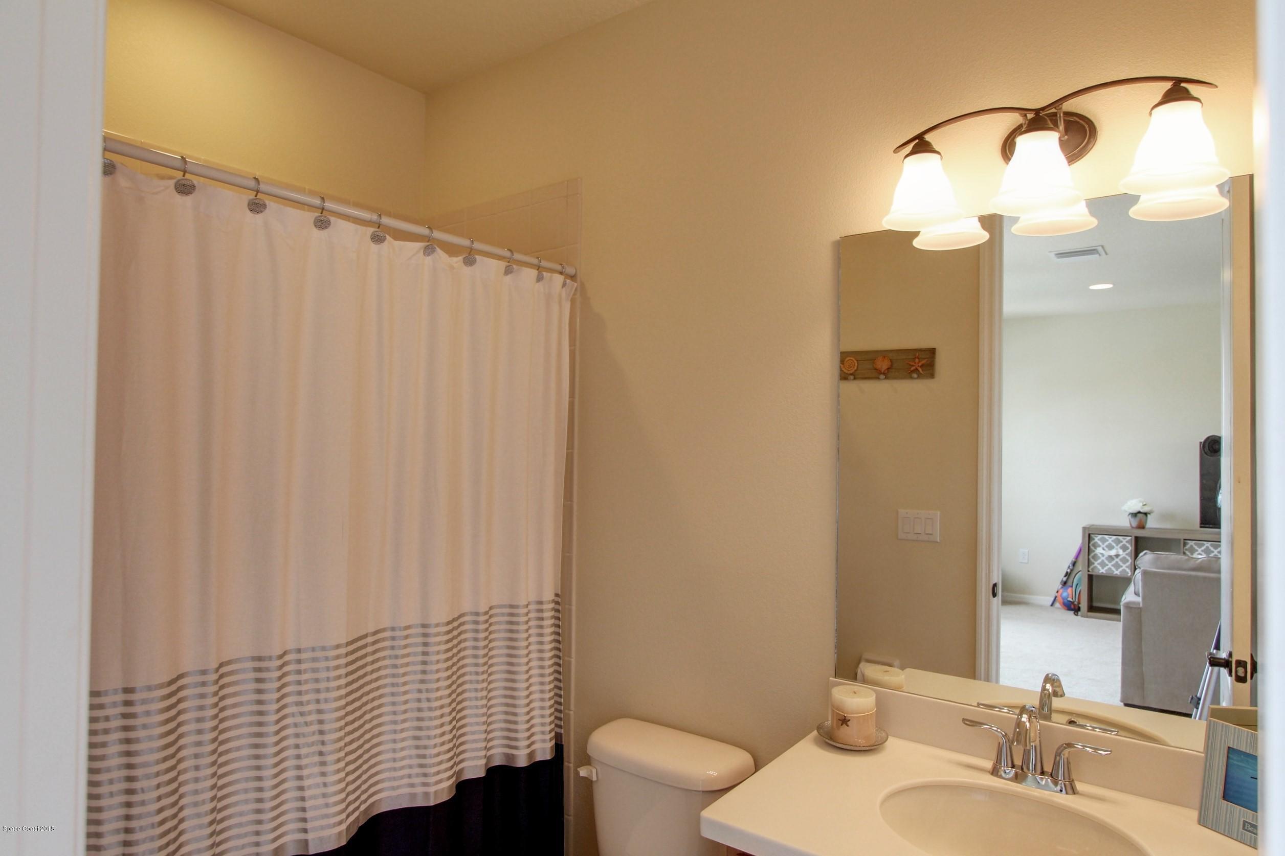 3235 Sedge Drive Rockledge, FL 32955 - Photo 19 of 34 a bathroom with a sink and a mirror