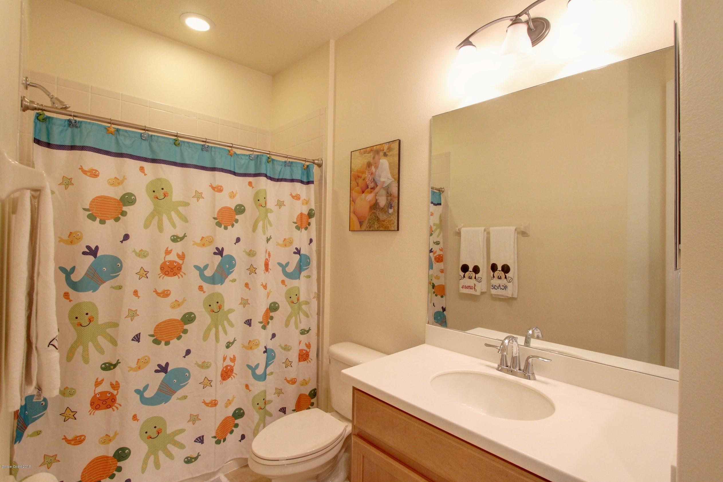 3235 Sedge Drive Rockledge, FL 32955 - Photo 29 of 34 a bathroom with a sink toilet and shower