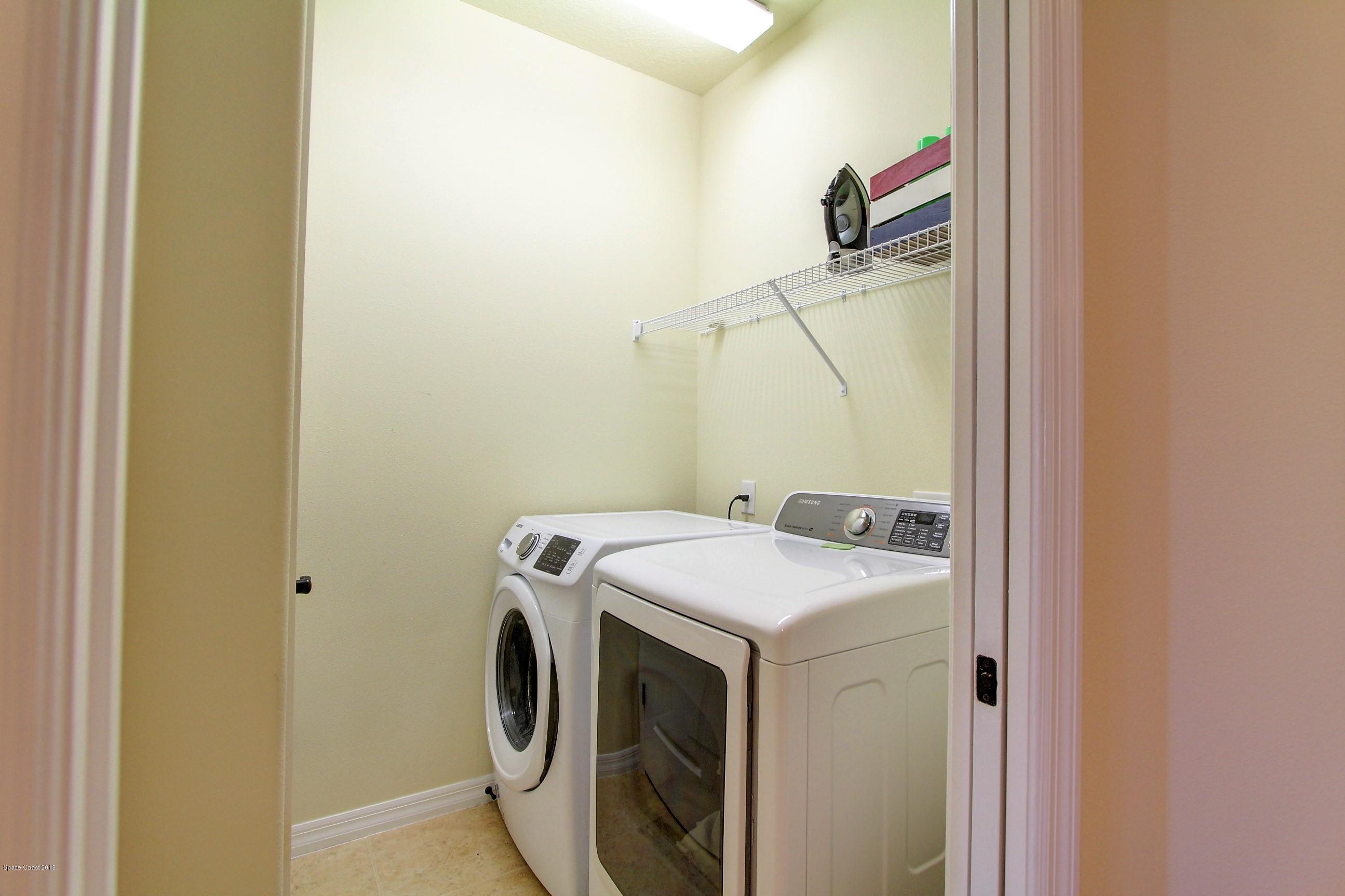 3235 Sedge Drive Rockledge, FL 32955 - Photo 30 of 34 a utility room with dryer and washer