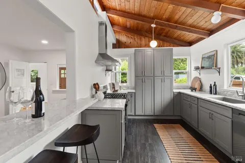 a kitchen with a sink appliances and cabinets