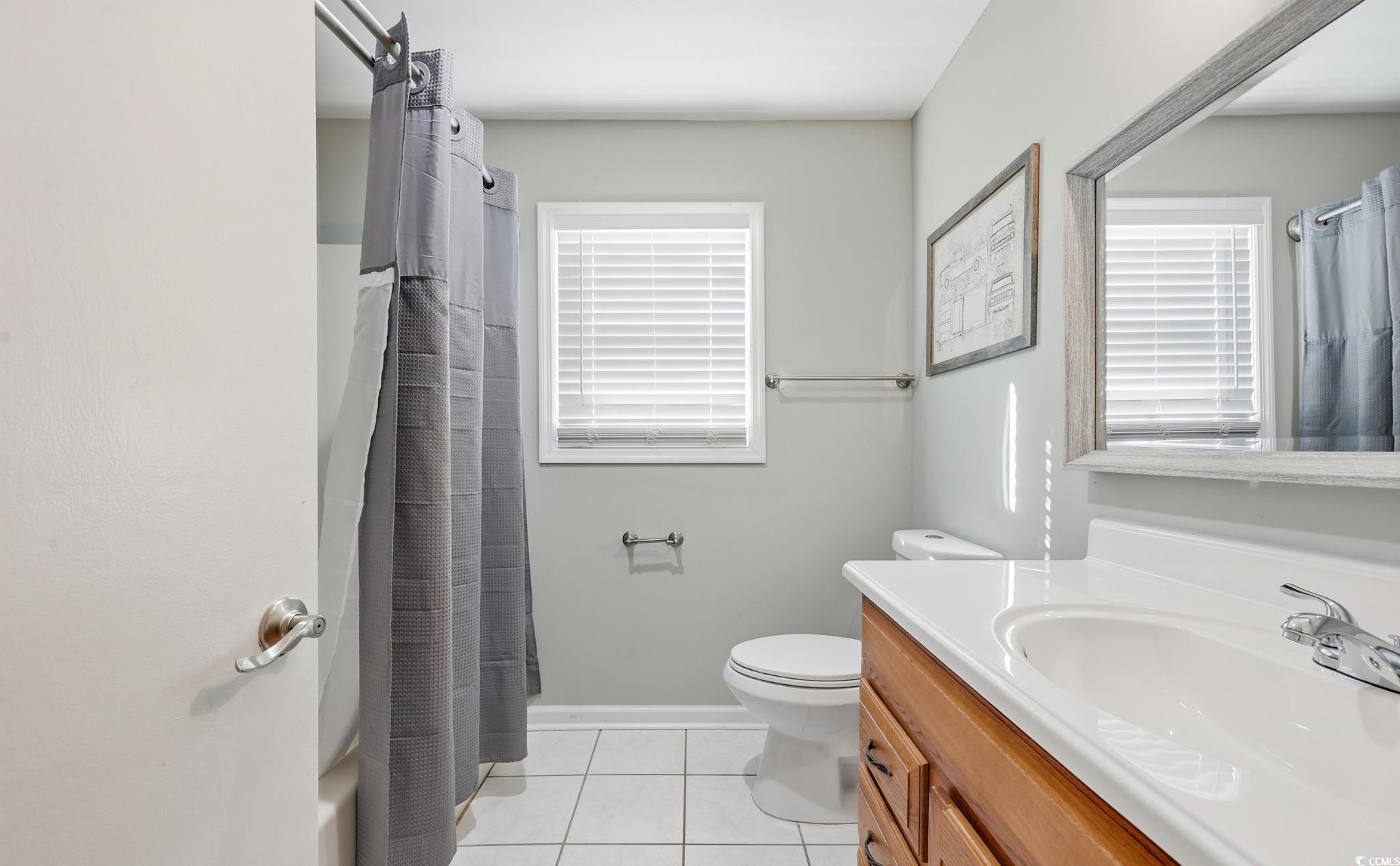 78 Wicklow Way Pawleys Island, SC 29585 - Photo 20 of 37 Full bath featuring vanity, light tile patterned floors, and healthy amount of natural light
