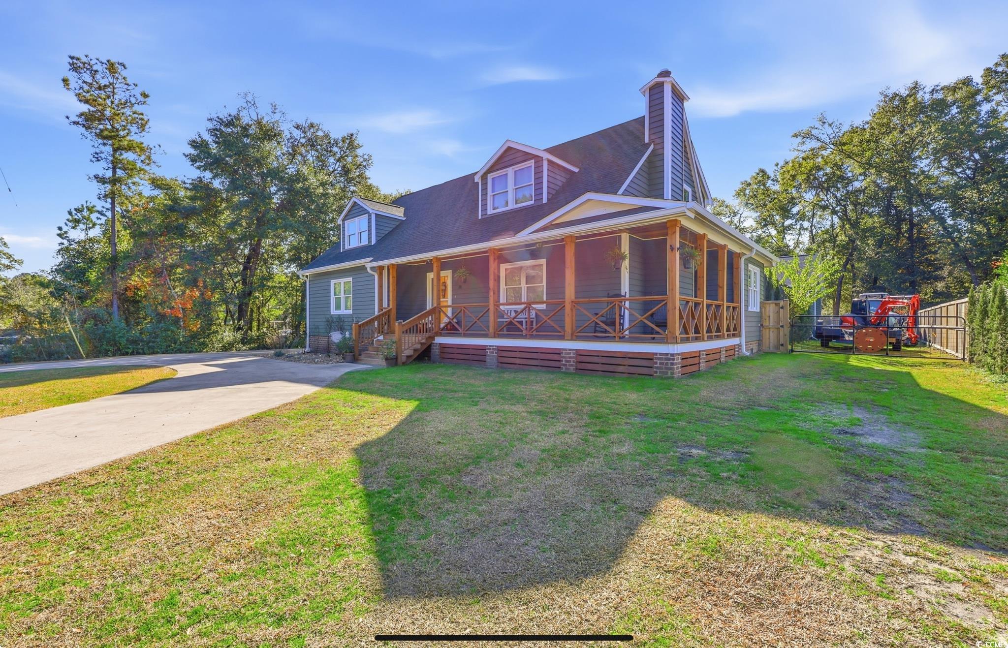 78 Wicklow Way Pawleys Island, SC 29585 - Photo 2 of 37 View of front of property featuring a porch, a chimney, and driveway