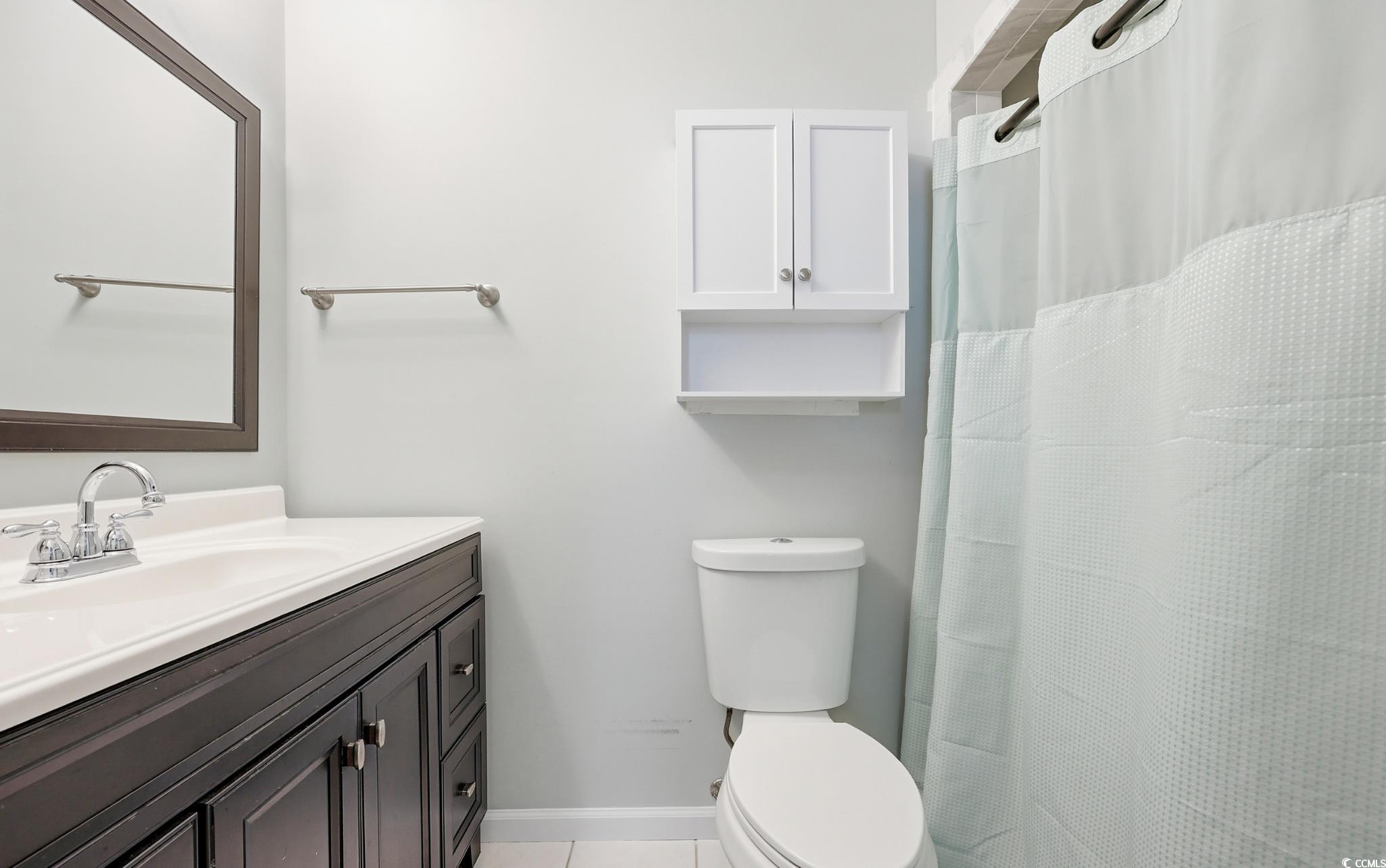 78 Wicklow Way Pawleys Island, SC 29585 - Photo 23 of 37 Bathroom with a shower with curtain, vanity, and light tile patterned floors