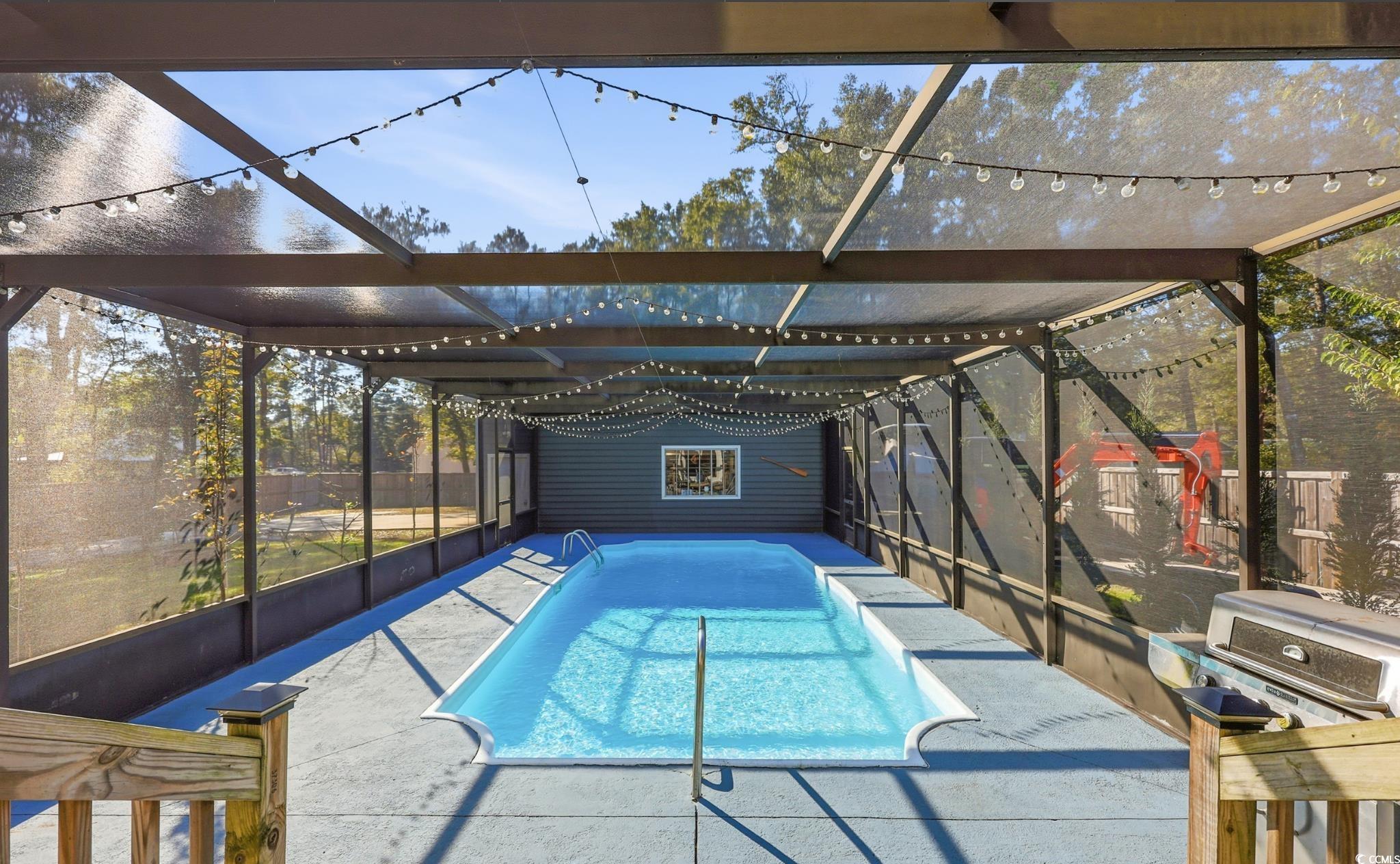 78 Wicklow Way Pawleys Island, SC 29585 - Photo 27 of 37 View of pool with a lanai and a sunroom