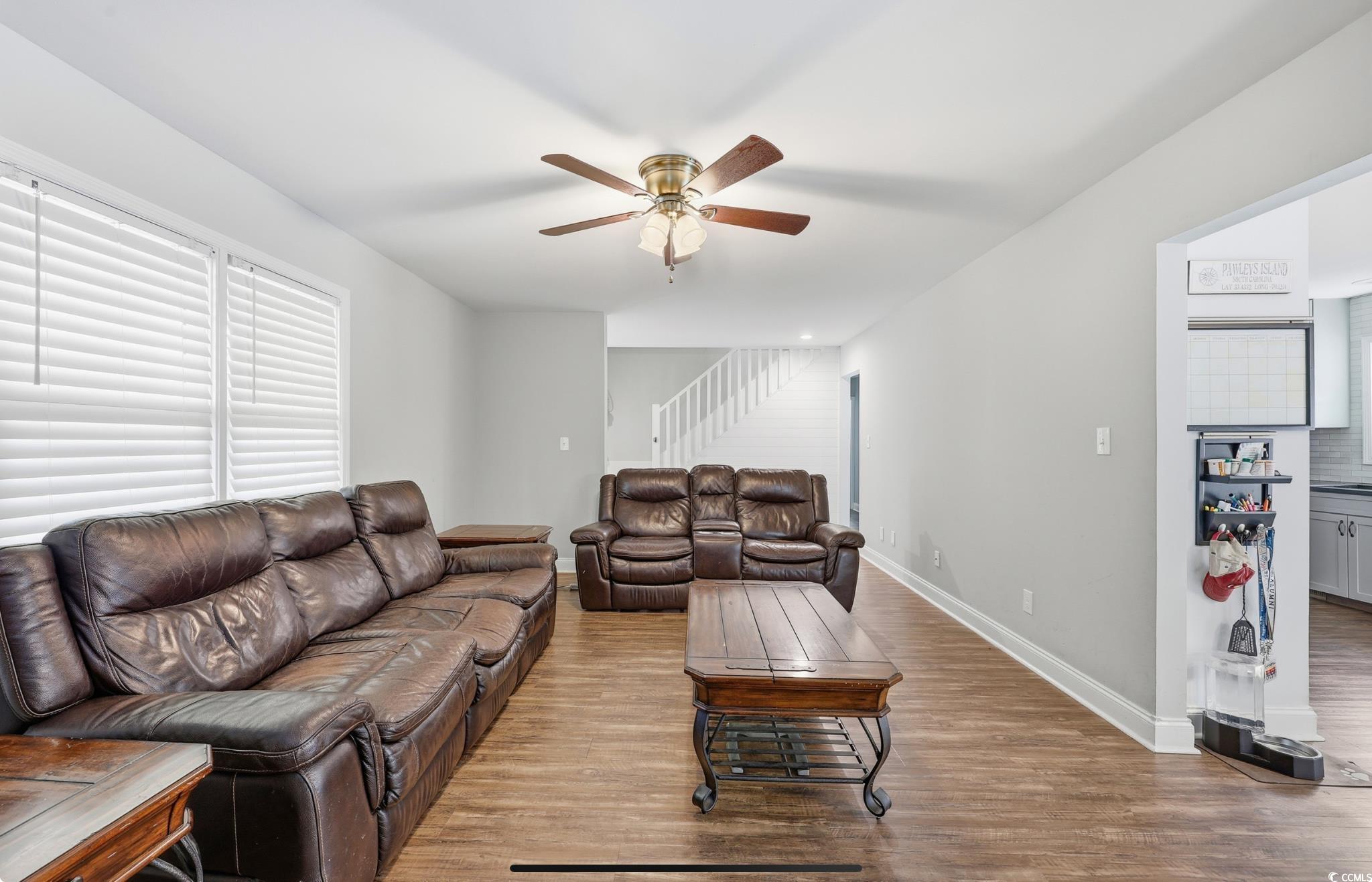 78 Wicklow Way Pawleys Island, SC 29585 - Photo 6 of 37 Living area with wood finished floors and a ceiling fan