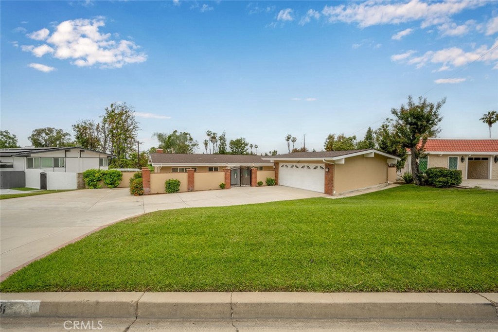 a front view of a house with a garden and deck