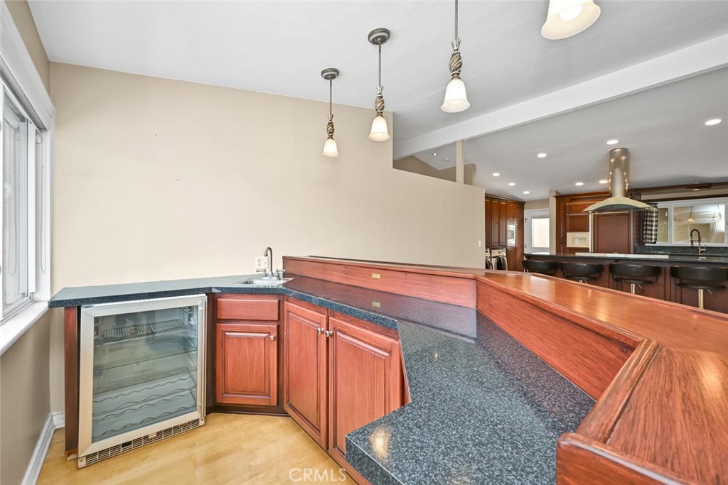 5531 Rockledge Drive Buena Park, CA 90621 - Photo 24 of 64 a large kitchen with stainless steel appliances granite countertop a sink and dishwasher a stove with wooden floor