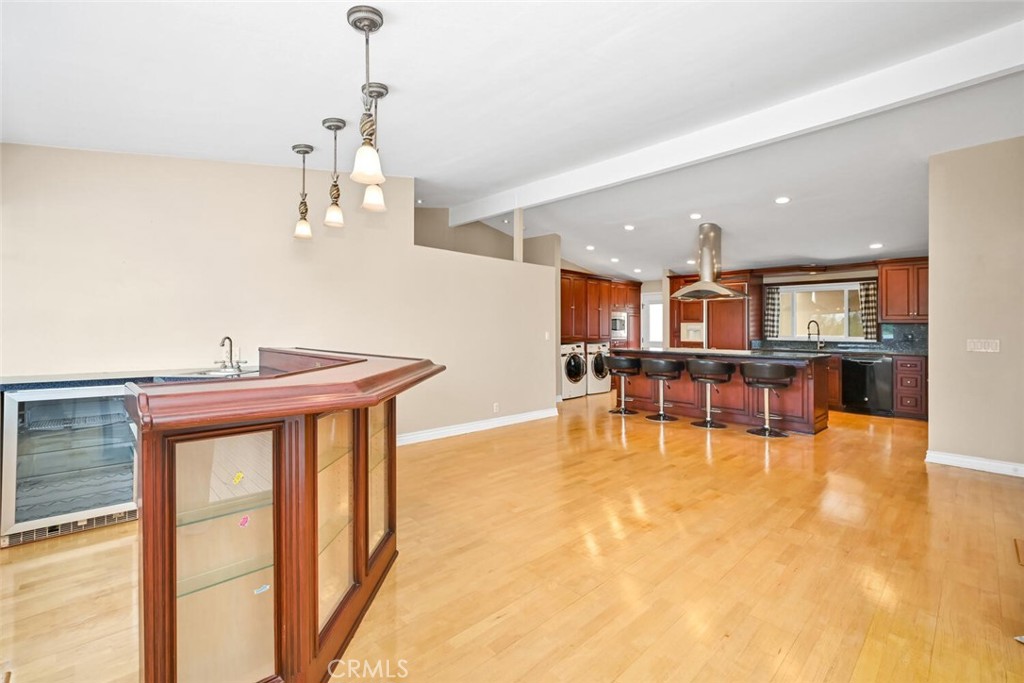 5531 Rockledge Drive Buena Park, CA 90621 - Photo 25 of 64 a view of a room with kitchen island stainless steel appliances wooden floor and windows