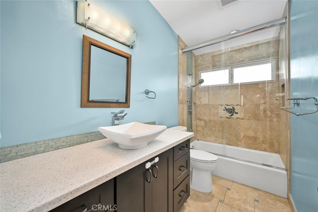 5531 Rockledge Drive Buena Park, CA 90621 - Photo 39 of 64 a bathroom with a sink a toilet a mirror and shower