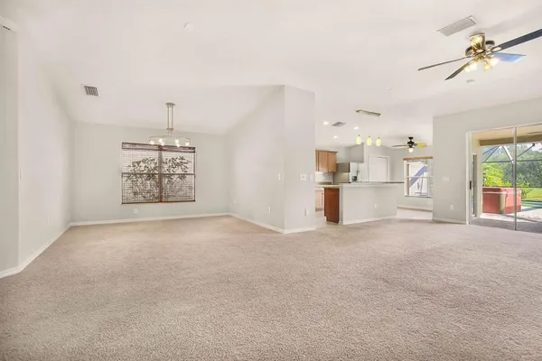 a view of a livingroom with a ceiling fan and window