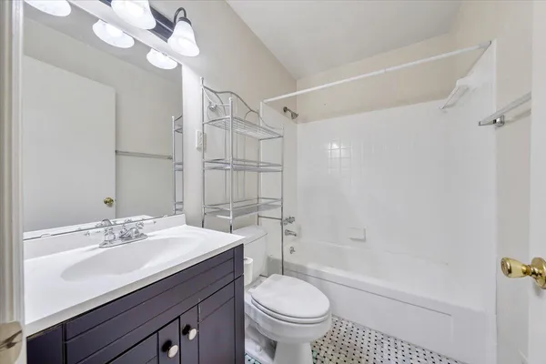 a bathroom with a sink a toilet a mirror and shower