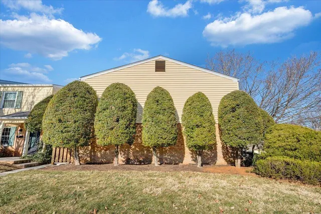 a large building with a big yard and large trees