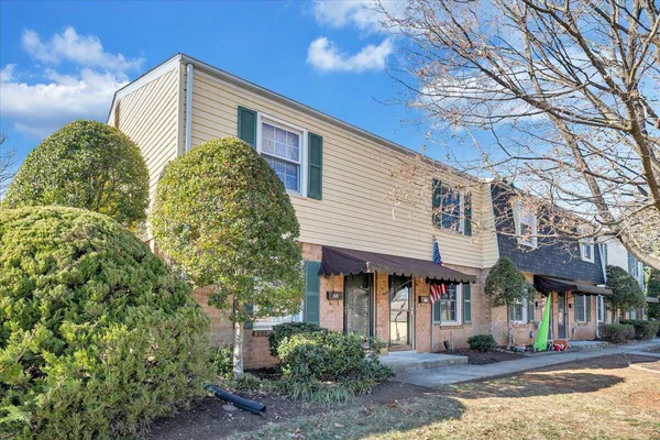 a front view of a building with a garden