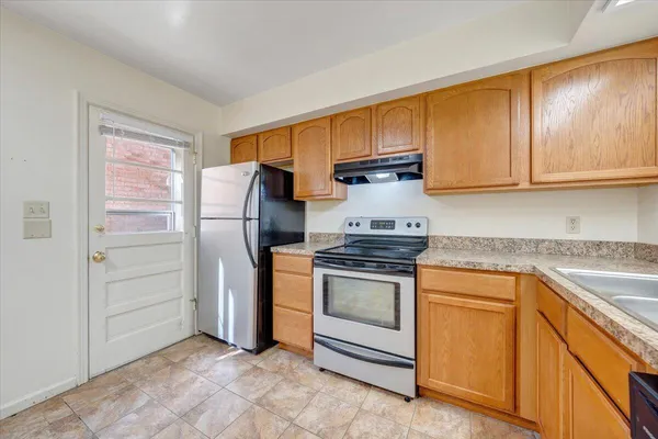 a kitchen with granite countertop cabinets and steel stainless steel appliances