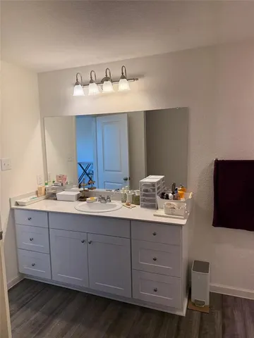 a bathroom with a double vanity sink and mirror