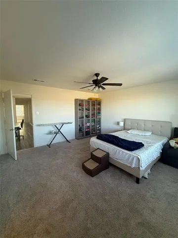 a bedroom with a bed and large mirror