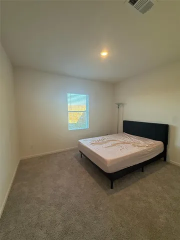 a bedroom with a table and bed