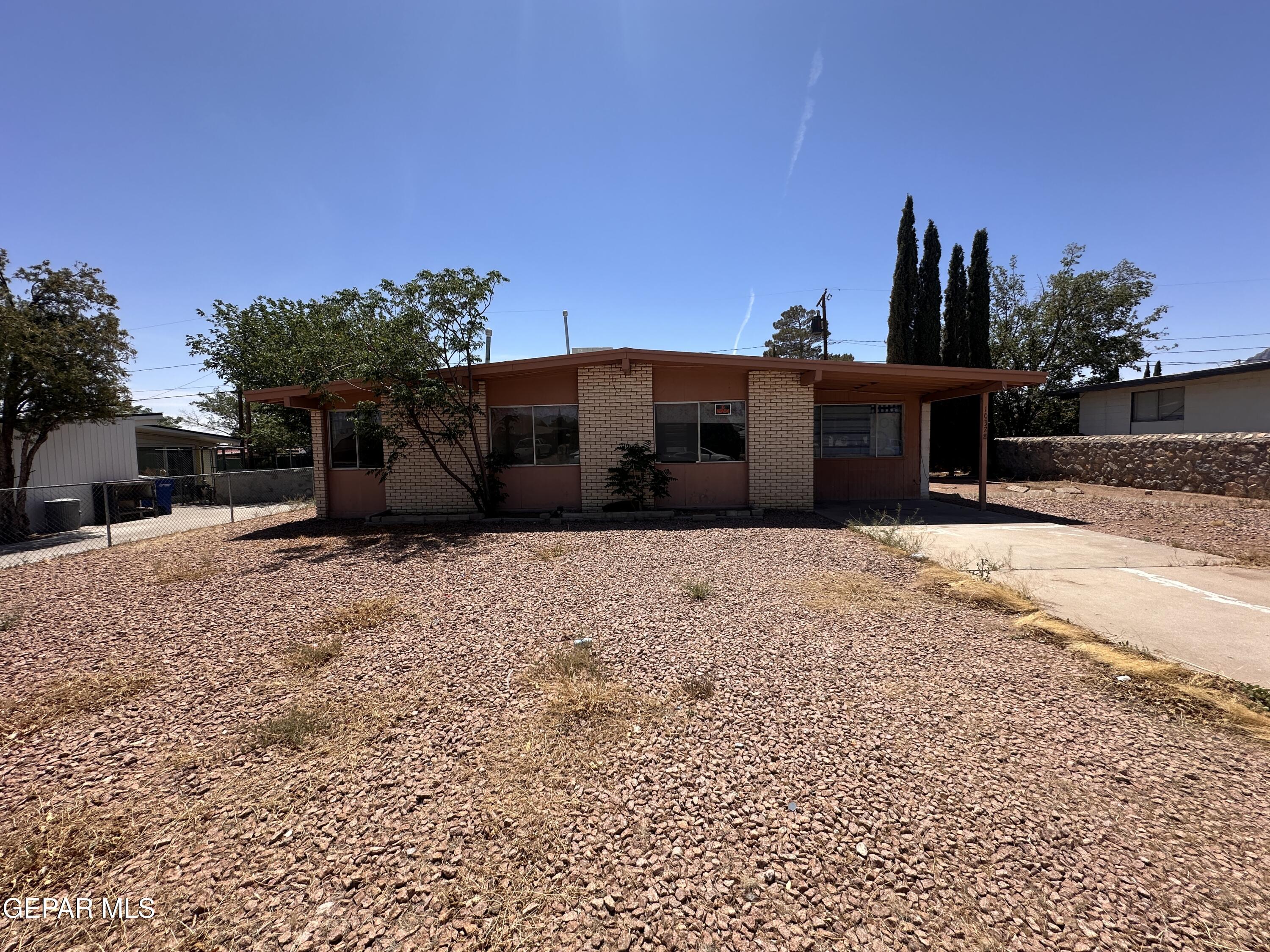 10378 Yellowstone Street El Paso, TX 79924 - Photo 3 of 5 a view of a house with a yard
