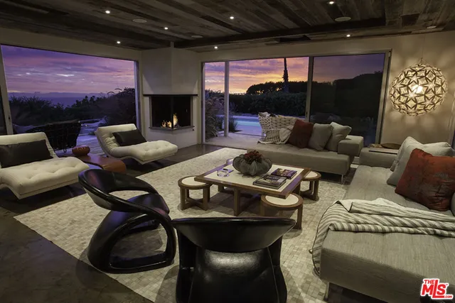 a living room with furniture a lamp and a fireplace