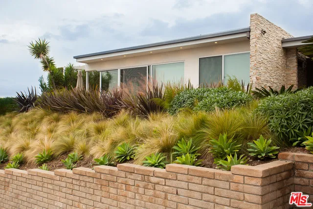 a front view of house with yard and seating space