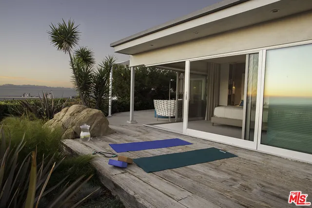 a balcony view with a seating space