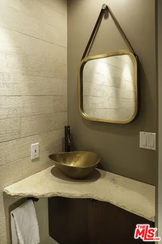 a bathroom with a sink and mirror