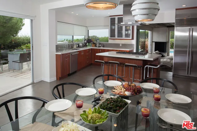 a kitchen with stainless steel appliances granite countertop a sink and a stove