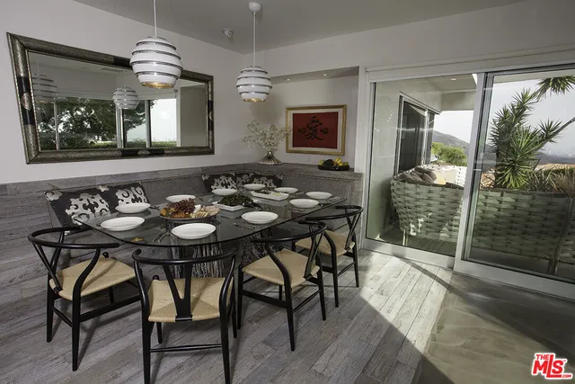 a view of a dining room with furniture window and wooden floor