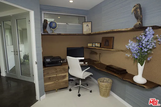 a view of a workspace with furniture and a potted plant
