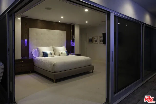 a bed room with a bed and a mirror