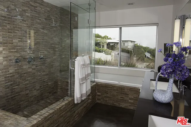 a bathroom with a glass shower door