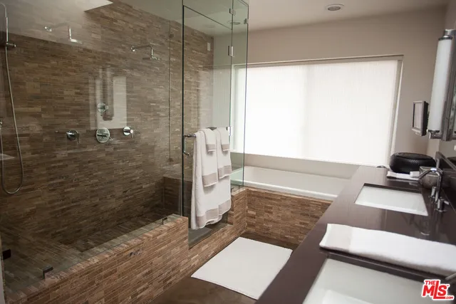 a bathroom with a sink double vanity and a mirror