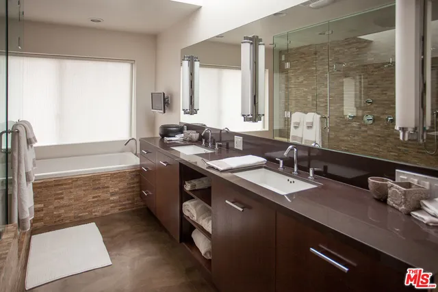 a large bed sitting in a bedroom next to a window