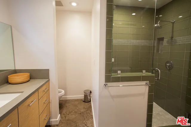 a spacious bathroom with a toilet sink and mirror