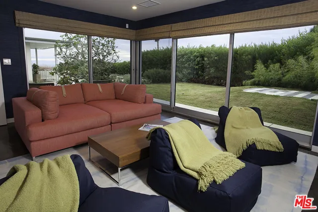 a balcony with furniture and a potted plant