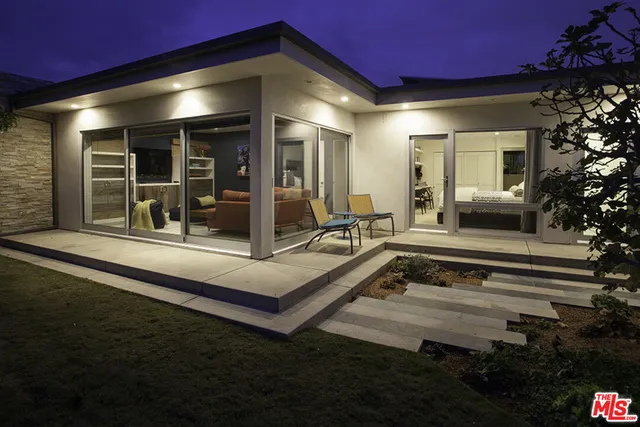 a view of a house with sitting area and garden