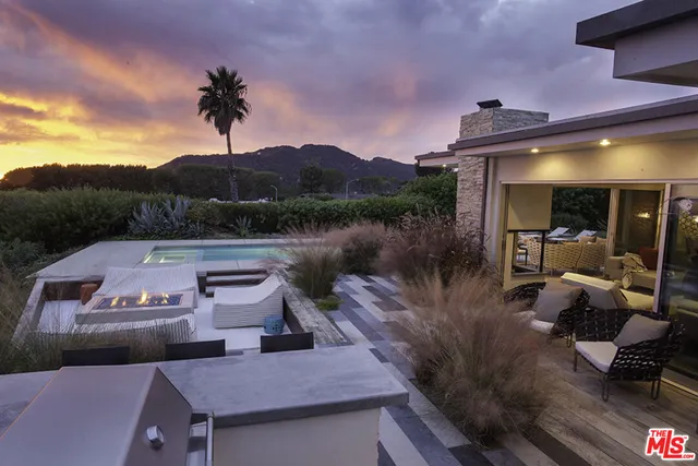 a view of a chairs and table in th patio
