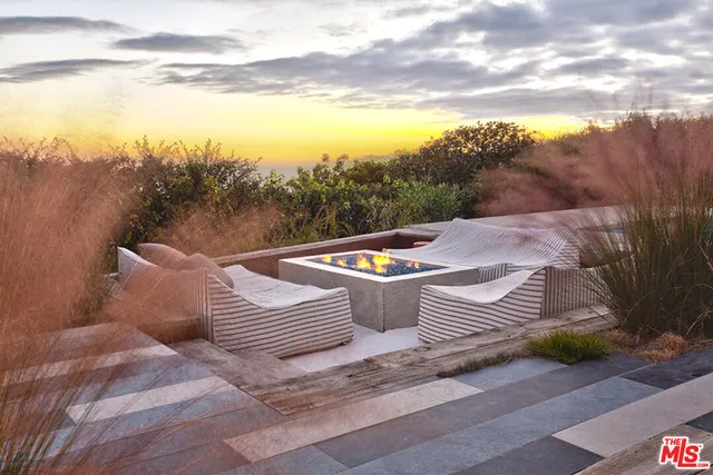 a view of a patio with a table and chairs