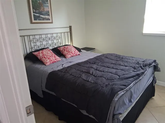 a bedroom with a bed and window