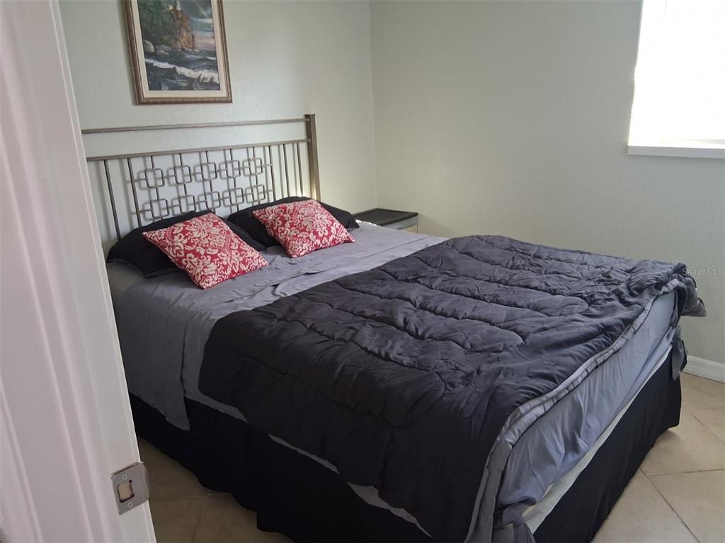 14982 Edgewater Circle Hudson, FL 34667 - Photo 15 of 22 a bedroom with a bed and window