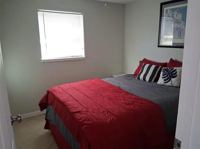 a bedroom with a bed and window