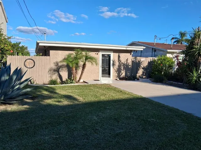 a view of a house with backyard and a patio