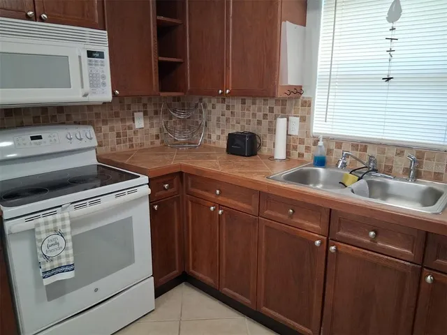 a kitchen with sink a oven and cabinets