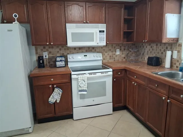 a kitchen with a stove and a microwave