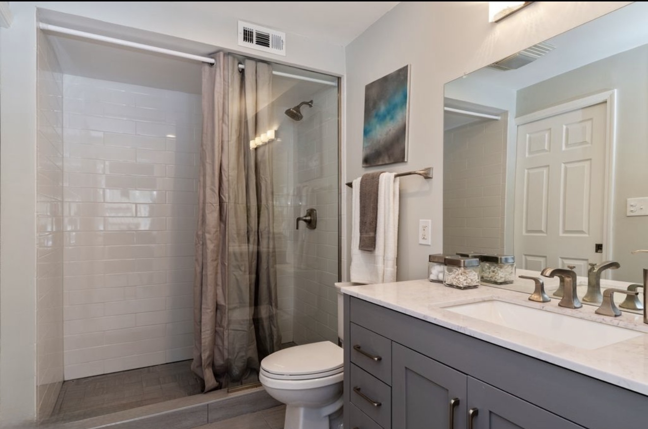 684 Pfingsten Road Northbrook, IL 60062 - Photo 24 of 33 a bathroom with a granite countertop sink toilet and shower